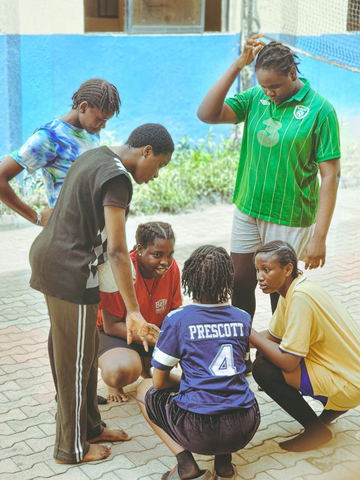 Mastering the First Impression: Your intriguing post title goes here A diverse group of young athletes discussing strategy outdoors, showing teamwork.