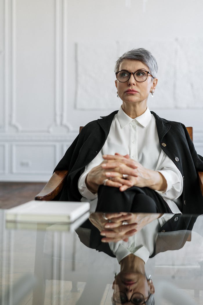 Confident woman in office setting reflecting professionalism and poise.