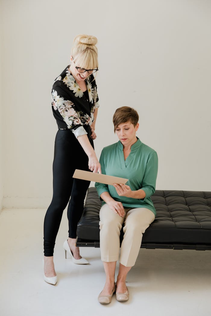 The Art of Drawing Readers In: Your attractive post title goes here Two professional women engaged in a mentoring conversation in a modern office space.
